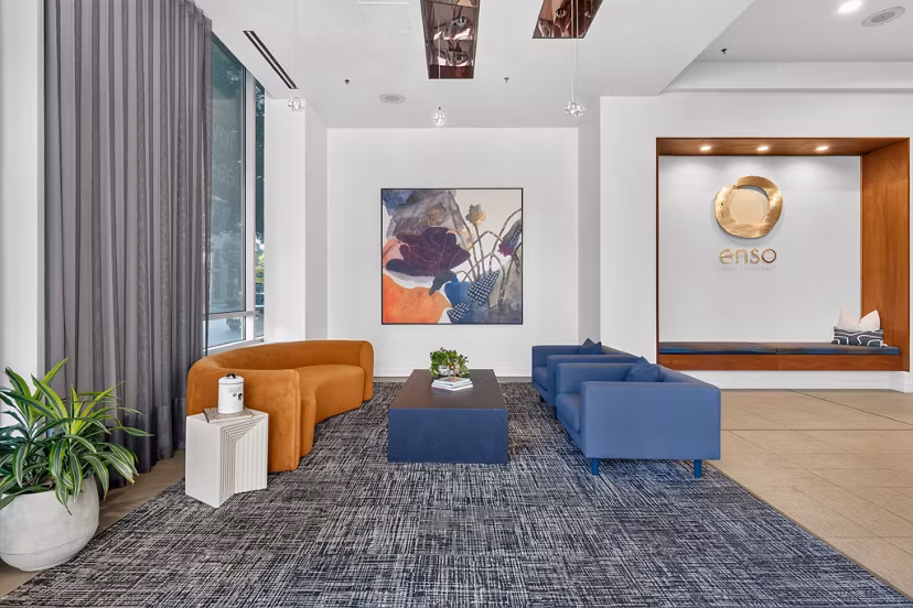 Clubhouse game room featuring billiards and lounging area at Enso Apartments, a luxury community by Greystar