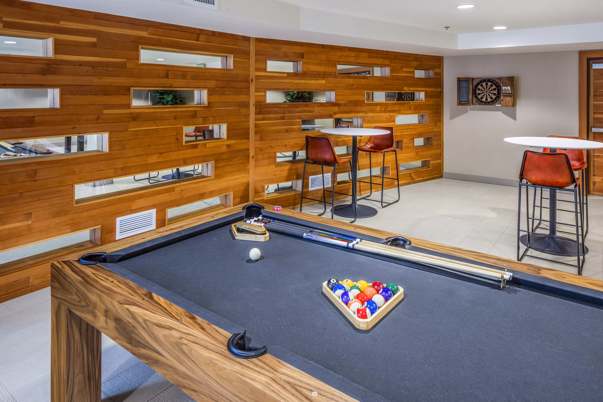 Clubhouse game room featuring billiards and lounging area at Enso Apartments, a luxury community by Greystar