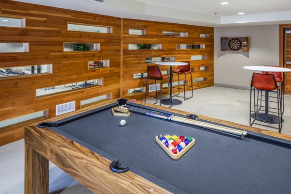 Clubhouse game room featuring billiards and lounging area at Enso Apartments, a luxury community by Greystar