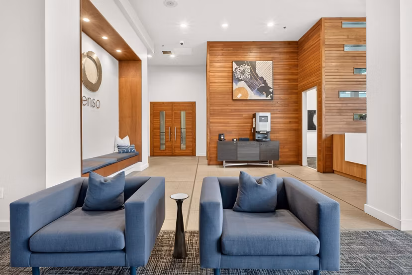 Clubhouse game room with billiards tables and lounge seating at Enso Apartments