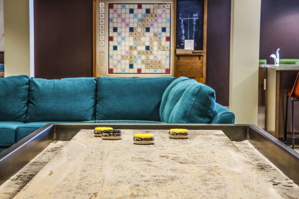 Clubhouse game room with billiards tables and lounge seating at Enso Apartments