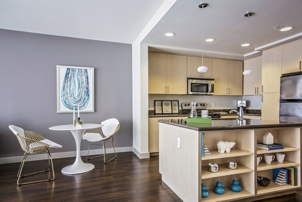 Dining room with elegant modern dÃ©cor featuring a chic chandelier at Enso Apartments