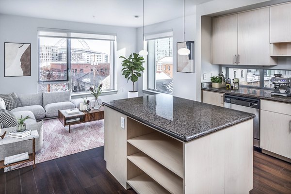 Modern kitchen with sleek appliances and marble countertops at Enso Apartments