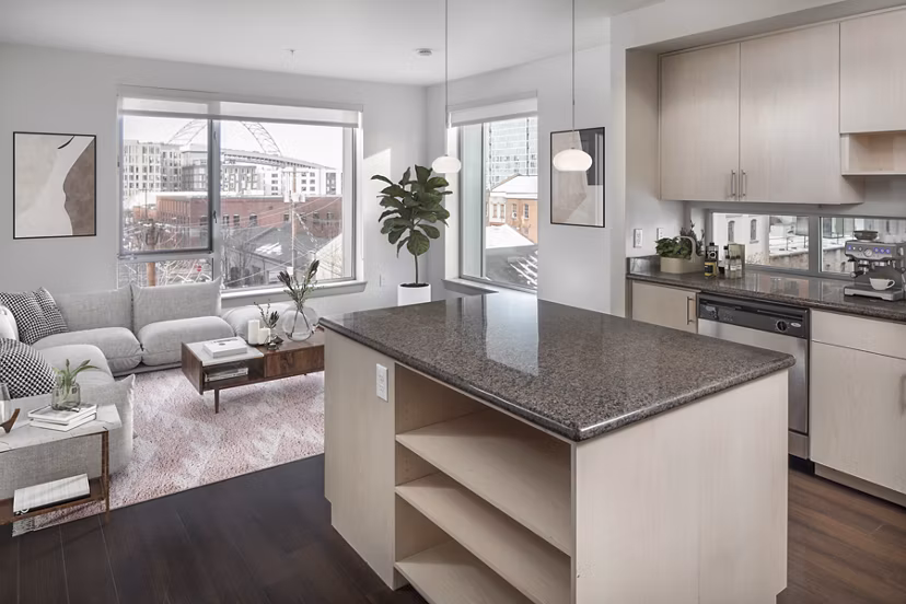 Modern kitchen with stainless steel appliances and quartz countertops in Enso Apartments