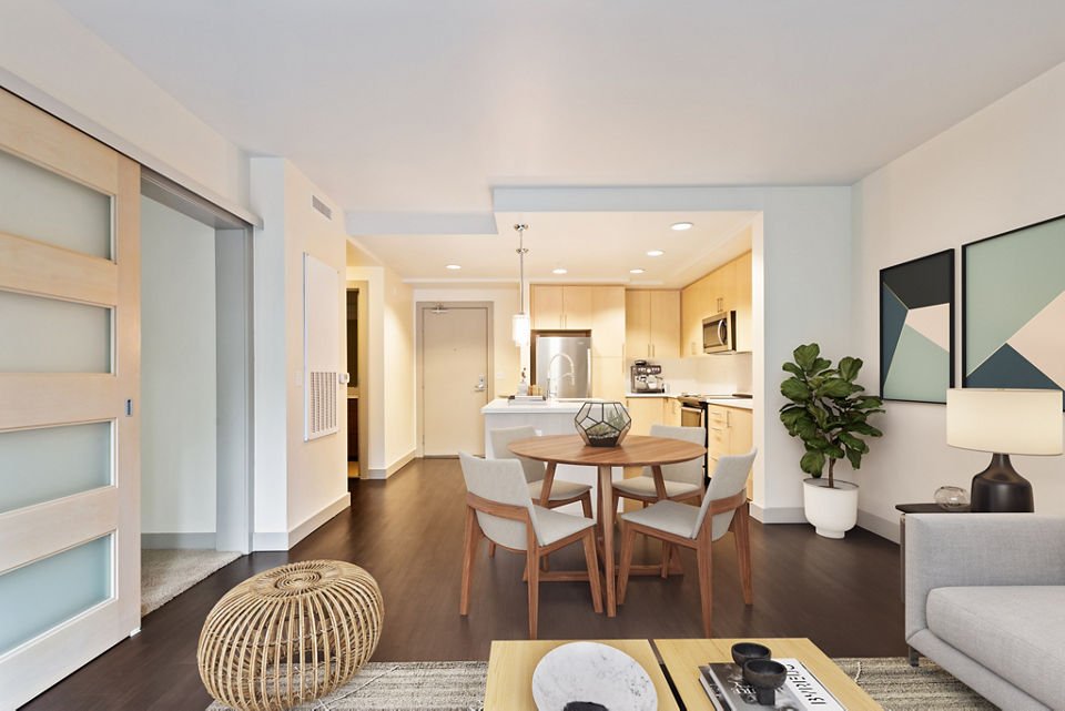 Modern living room with sleek furniture and ample natural light at Enso Apartments