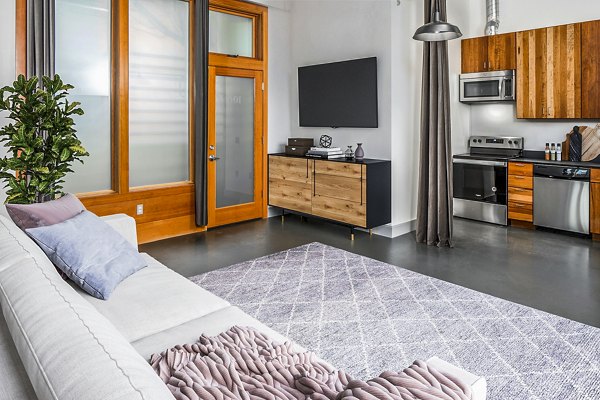 Modern living room with sleek furnishings and city views at Enso Apartments