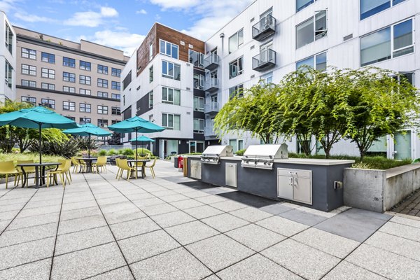Outdoor grill area with modern seating at Enso Apartments, luxurious outdoor living space in a premium property
