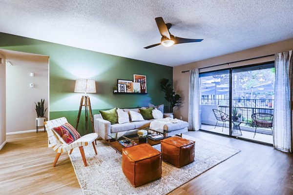 Modern living room with sleek furniture and large windows at Rockledge Fairways Apartments