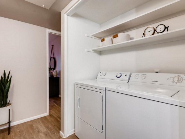 Laundry room with modern appliances at Rockledge Fairways Apartments