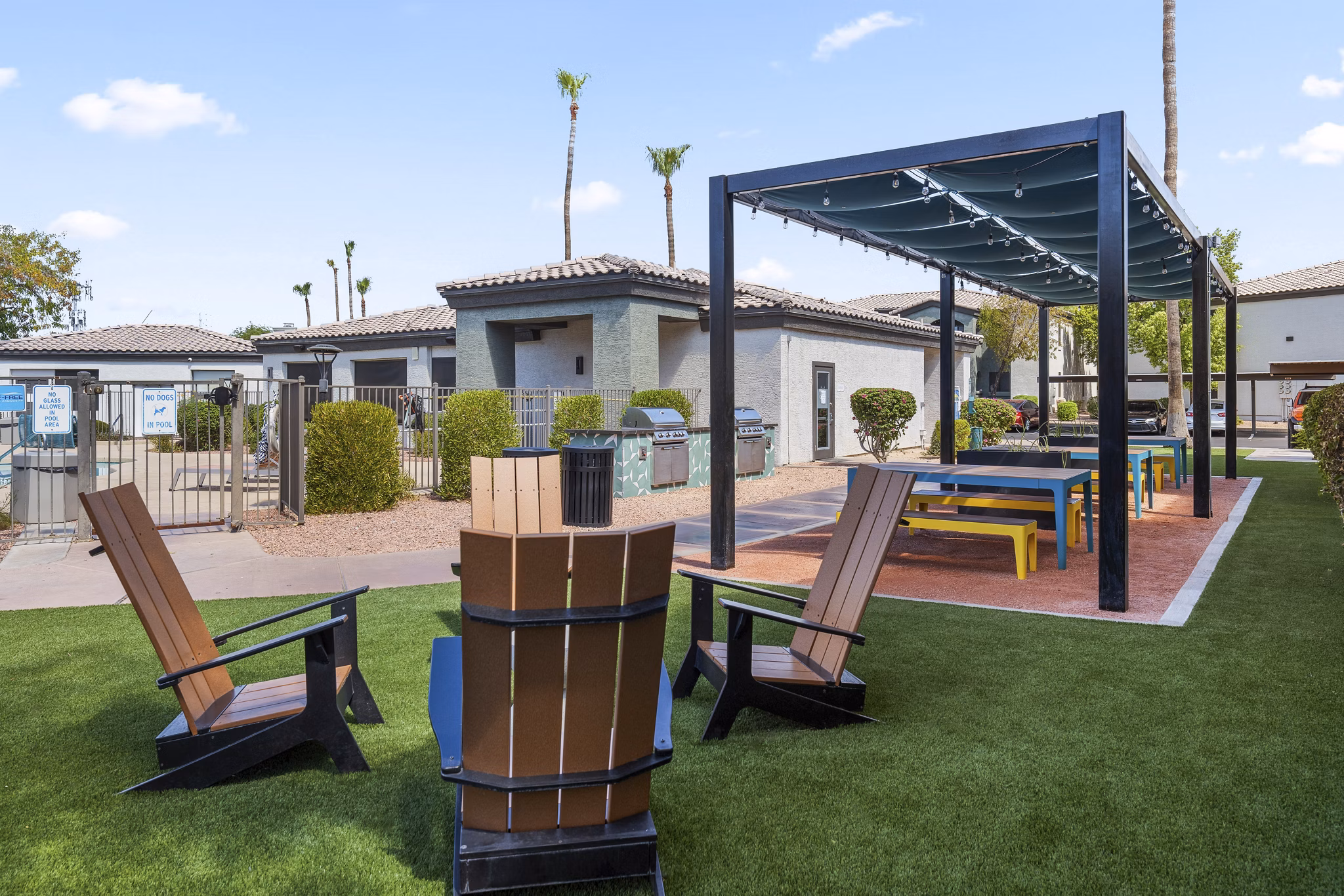 Spacious outdoor patio with stylish seating at Palm Court Apartments offering luxury living