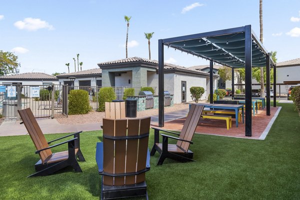 Spacious outdoor patio with stylish seating at Palm Court Apartments offering luxury living