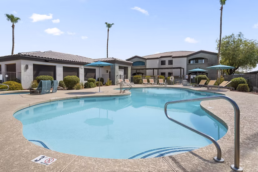 Palm Court Apartments: Resort-style pool with lounging areas