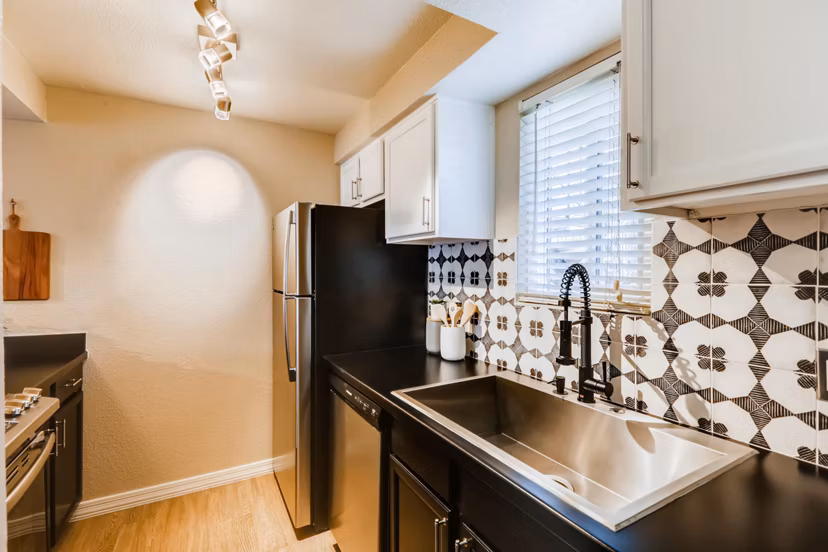 Modern kitchen with granite countertops and stainless steel appliances at Scottsdale Gateway Apartments
