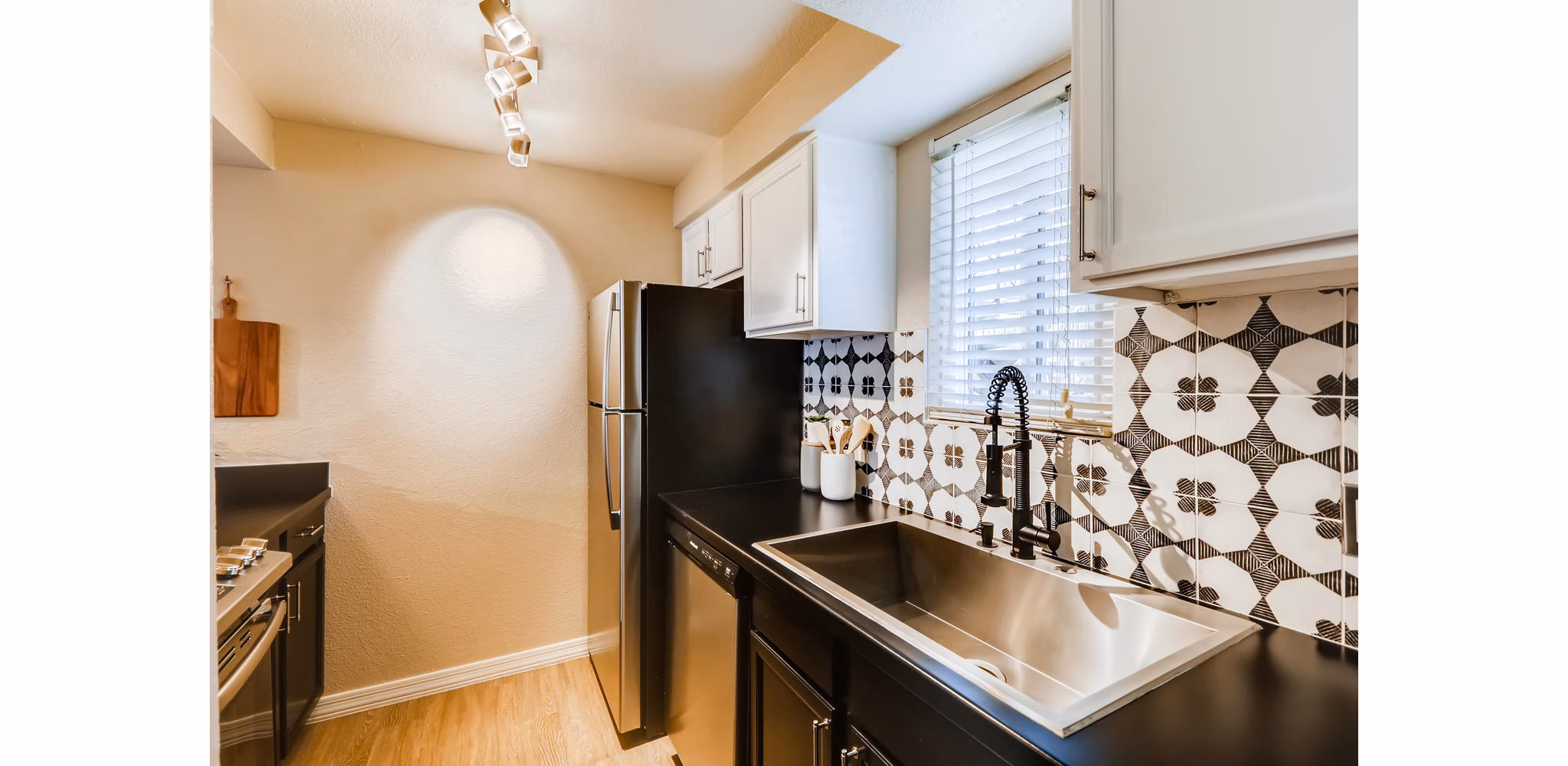 Modern kitchen with granite countertops and stainless steel appliances at Scottsdale Gateway Apartments