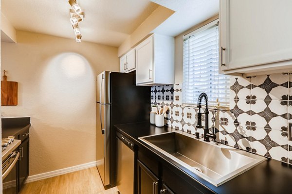 Modern kitchen with granite countertops and stainless steel appliances at Scottsdale Gateway Apartments