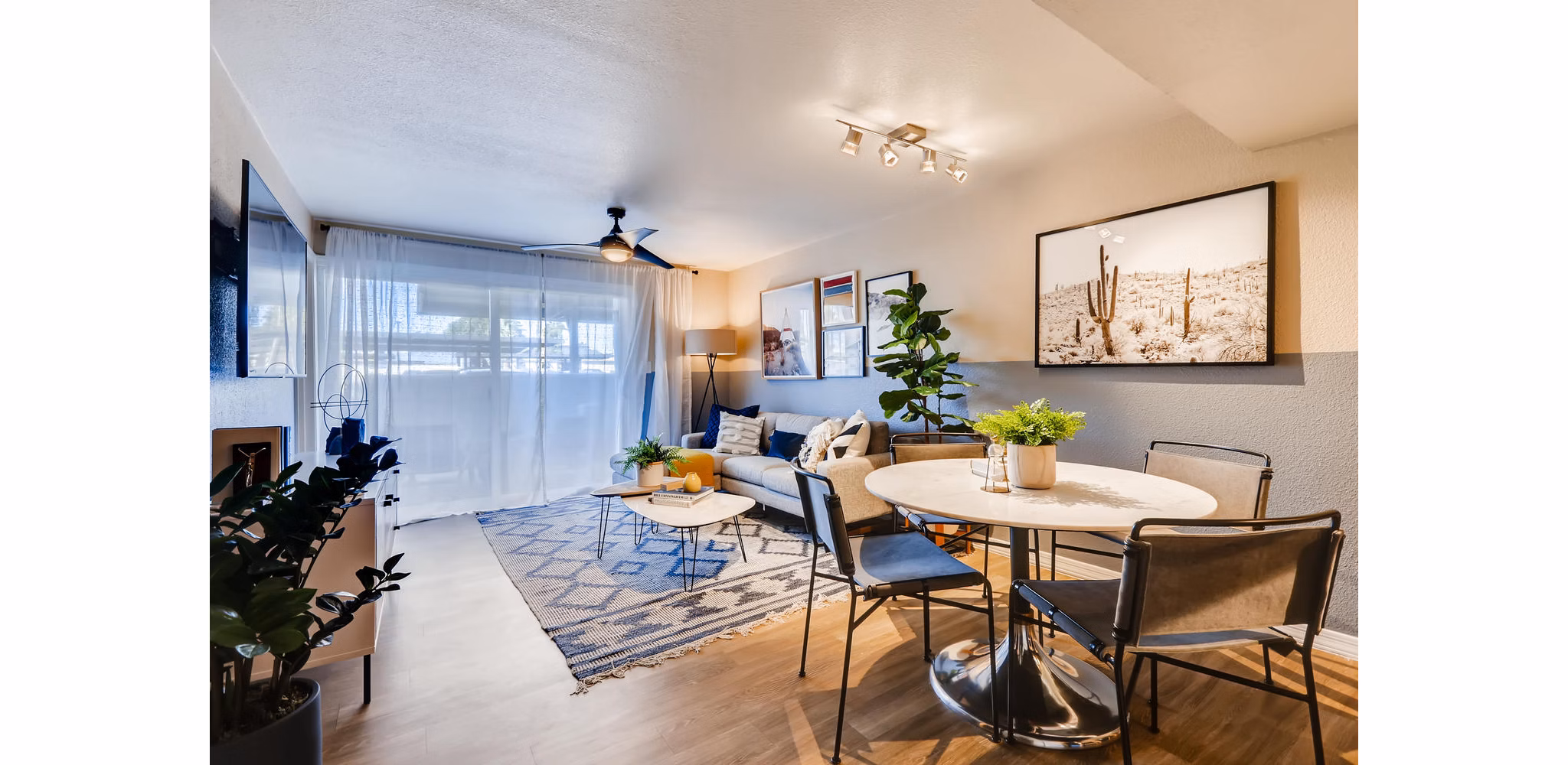 Living room with modern decor and large windows at Scottsdale Gateway Apartments in Scottsdale, offering comfort and style for residents