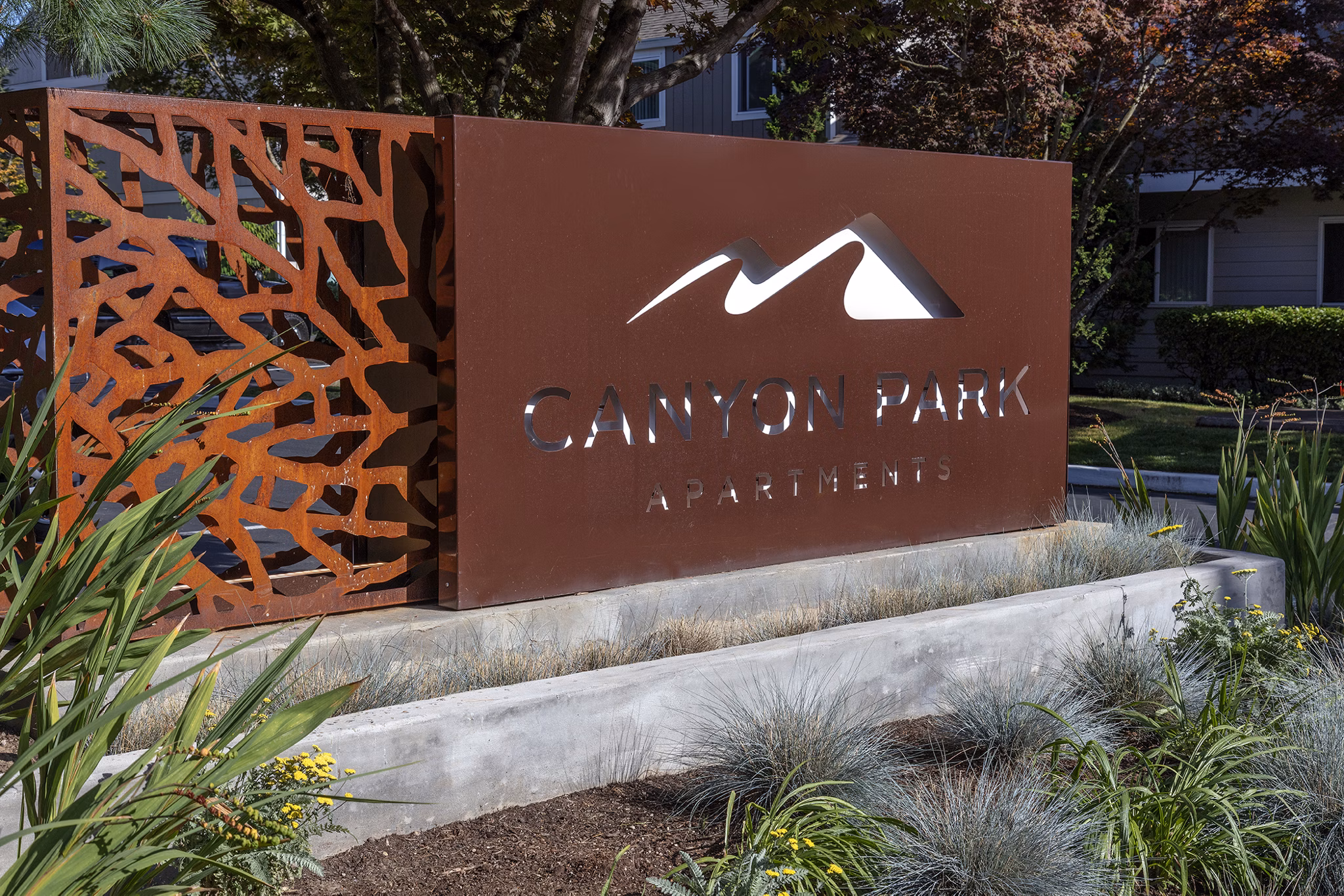Canyon Park Apartments: Contemporary entrance signage at luxury apartments in serene neighborhood setting