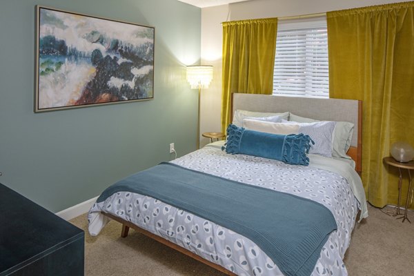 Cozy bedroom with modern decor at Canyon Park Apartments, featuring plush bedding and ample natural light, ideal for luxury living