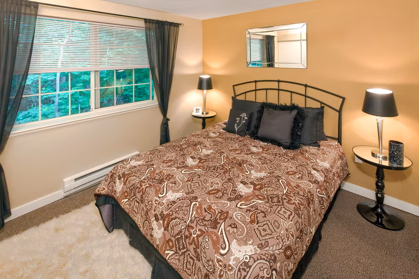 Modern bedroom with large windows at Landmark at Tanasbourne Apartments