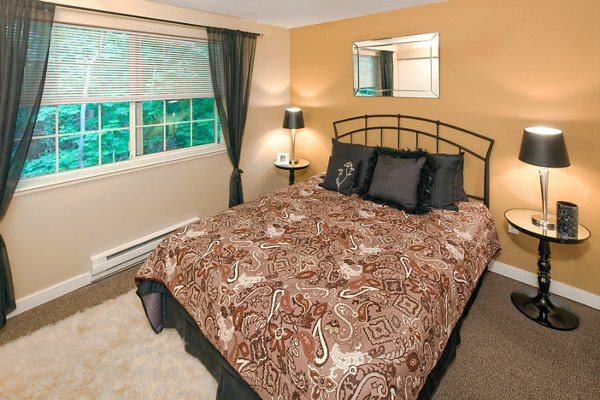 Modern bedroom with large windows at Landmark at Tanasbourne Apartments