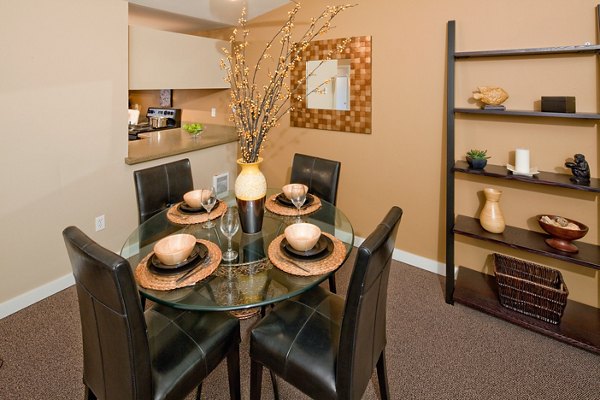 Elegant dining room with modern furnishings at Landmark at Tanasbourne Apartments, featuring luxury living by Greystar