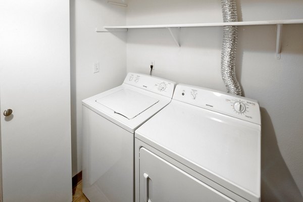 Laundry room equipped with modern washers and dryers at Landmark at Tanasbourne Apartments