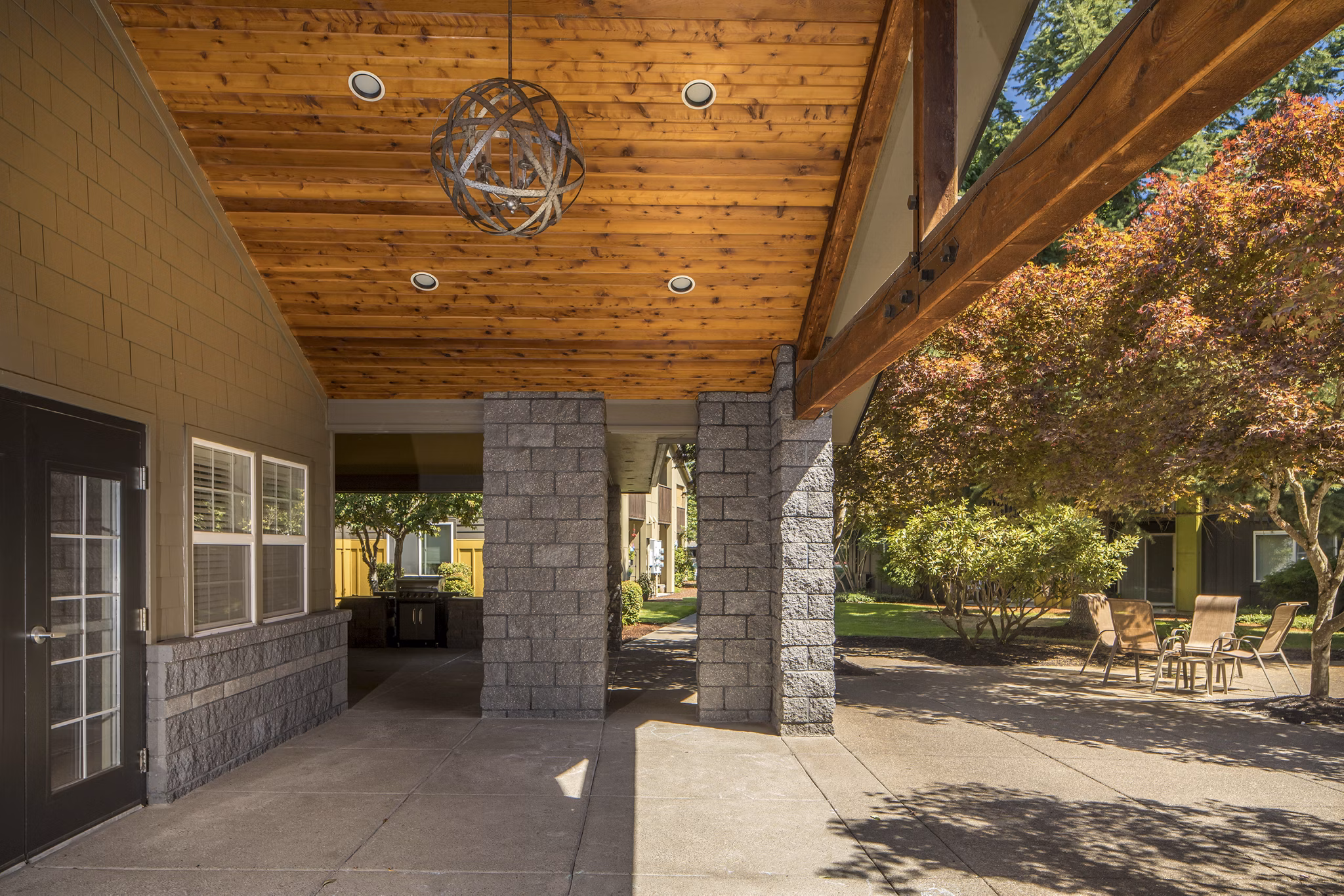 Outdoor patio with comfy seating at Crescent Park Apartments, offering a relaxing communal space for residents to enjoy fresh air and socialize