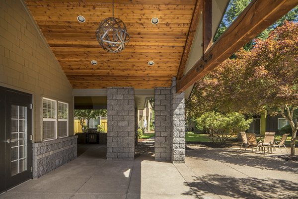 Outdoor patio with comfy seating at Crescent Park Apartments, offering a relaxing communal space for residents to enjoy fresh air and socialize