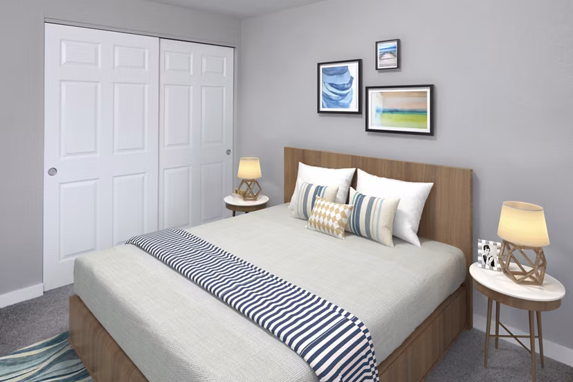 Cozy bedroom featuring plush bedding at Crescent Park Apartments, showcasing modern luxury living in a Greystar community