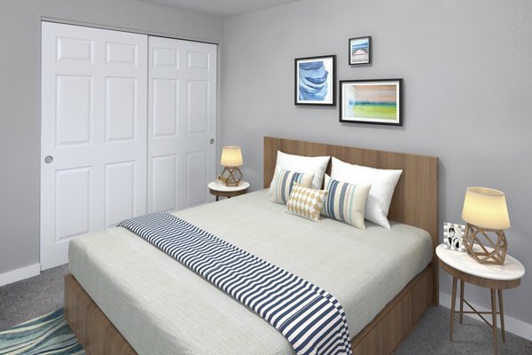 Cozy bedroom featuring plush bedding at Crescent Park Apartments, showcasing modern luxury living in a Greystar community