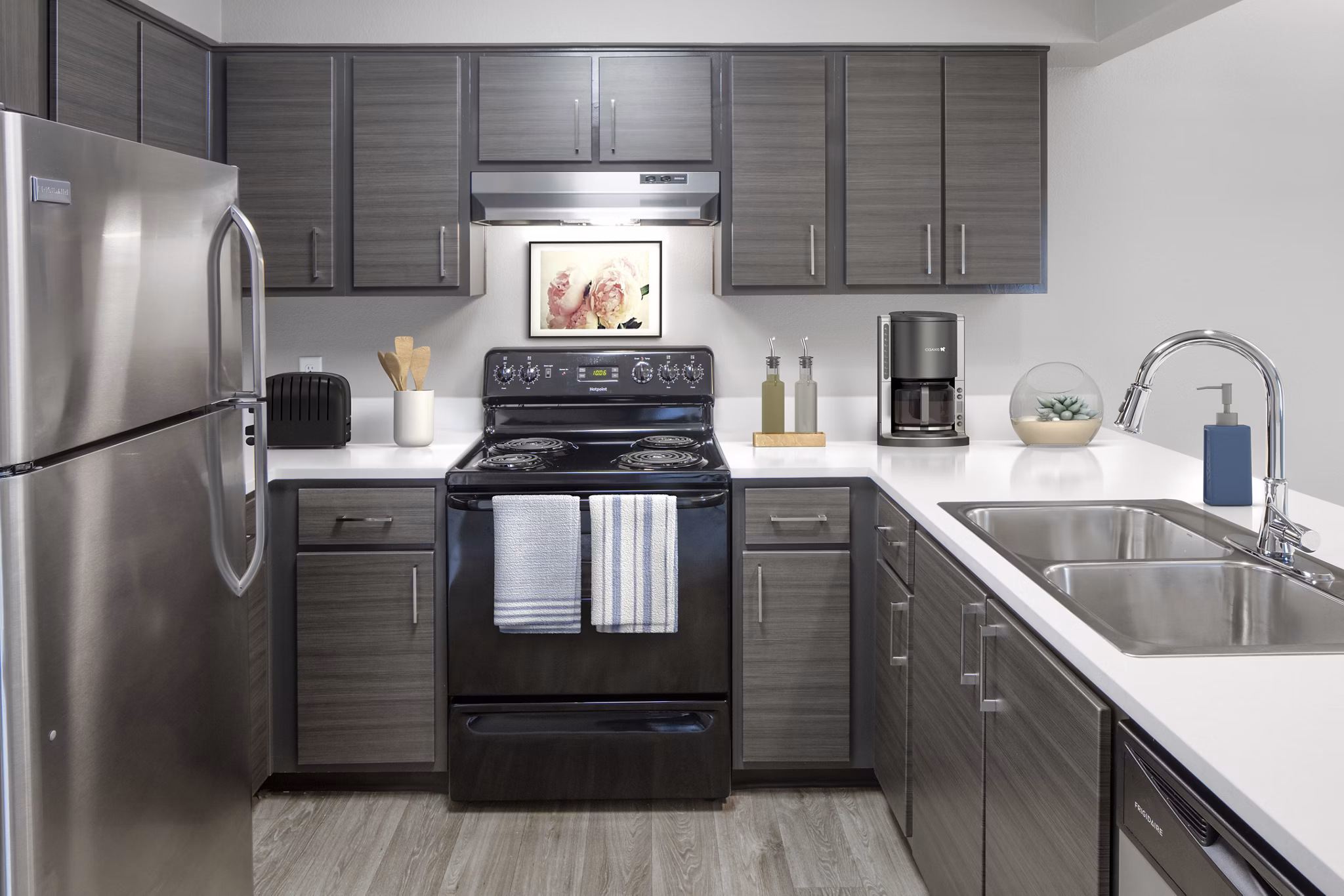Modern kitchen with sleek countertops and stainless steel appliances at Crescent Park Apartments