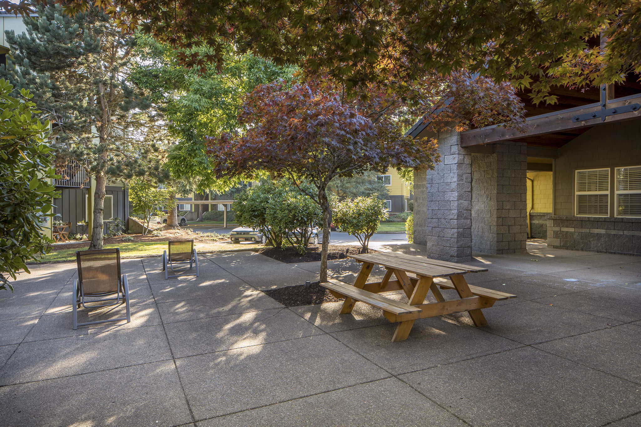 Crescent Park Apartments: Tranquil courtyard with lush greenery and seating areas for relaxation