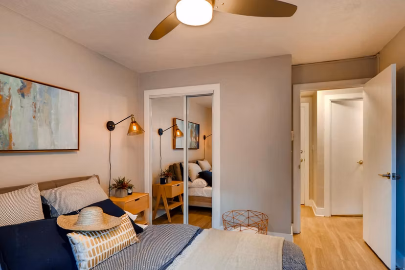 Cozy bedroom featuring modern decor and large window at Park Plaza Apartments