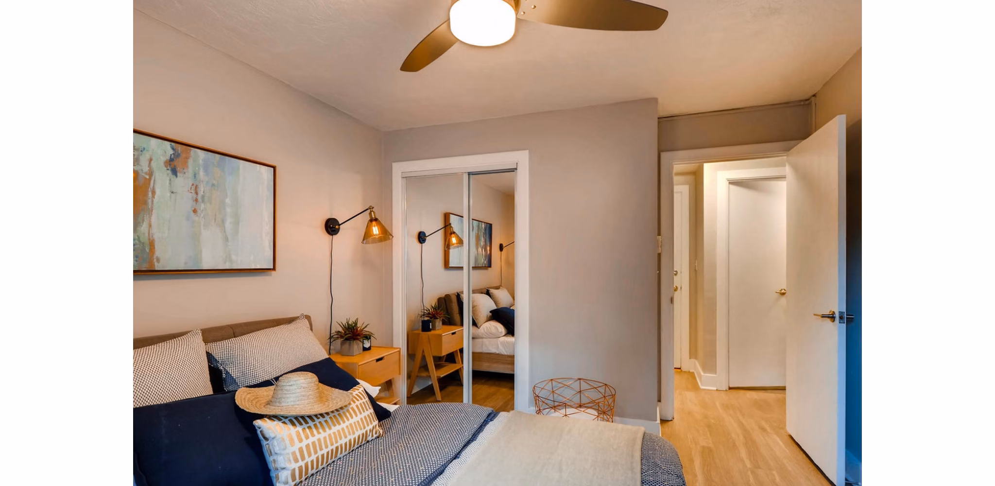 Cozy bedroom featuring modern decor and large window at Park Plaza Apartments