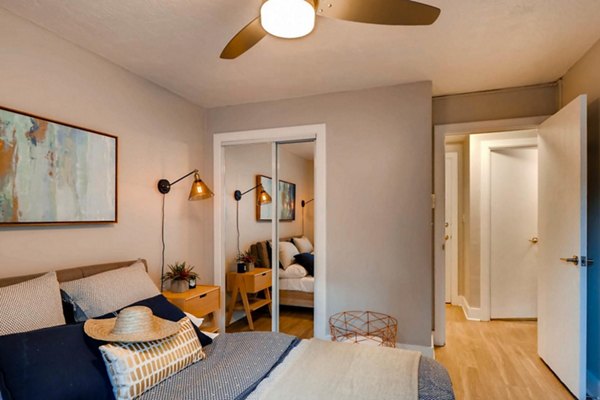 Cozy bedroom featuring modern decor and large window at Park Plaza Apartments
