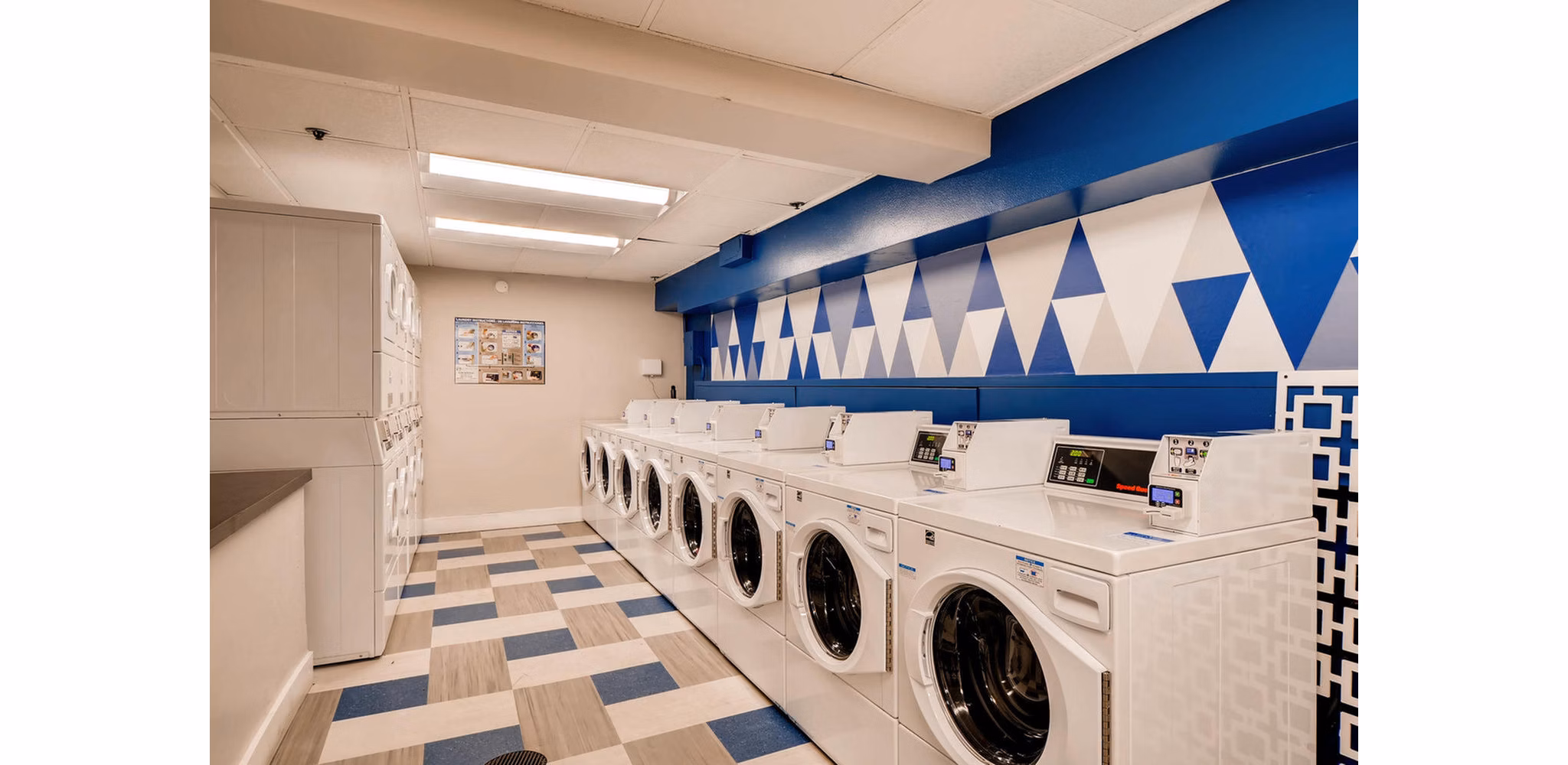 Modern laundry facility at Park Plaza Apartments offering high-end washing machines and dryers for convenient living