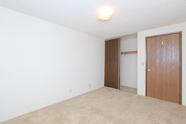 Cozy bedroom with ample natural light at Redwood Park Apartments