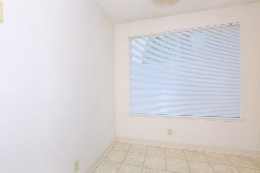 Cozy bedroom with elegant design at Redwood Park Apartments, featuring ample natural light and modern decor