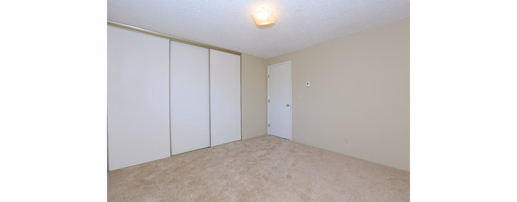 Cozy bedroom with stylish decor at Redwood Park Apartments, a Greystar luxury community, offering modern amenities and comfortable living spaces