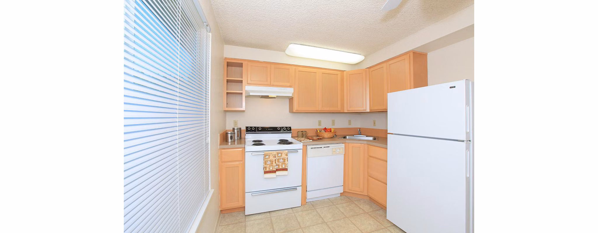 Modern kitchen with stainless steel appliances at Redwood Park Apartments