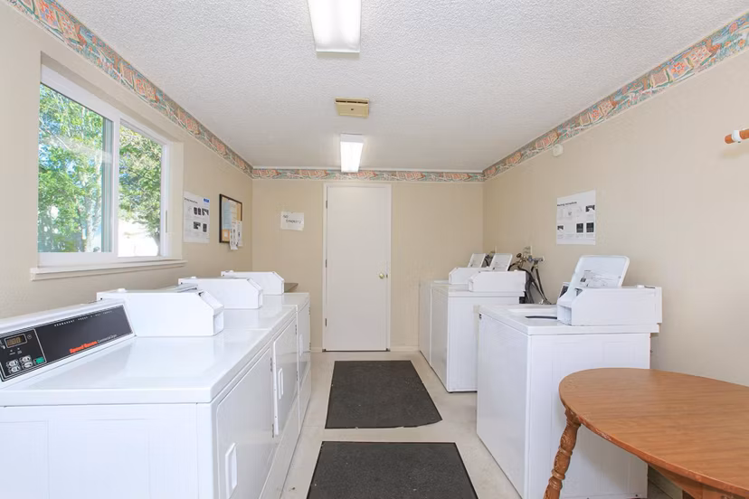 Modern laundry facility with high-efficiency machines at Redwood Park Apartments, ensuring convenience and efficiency for residents