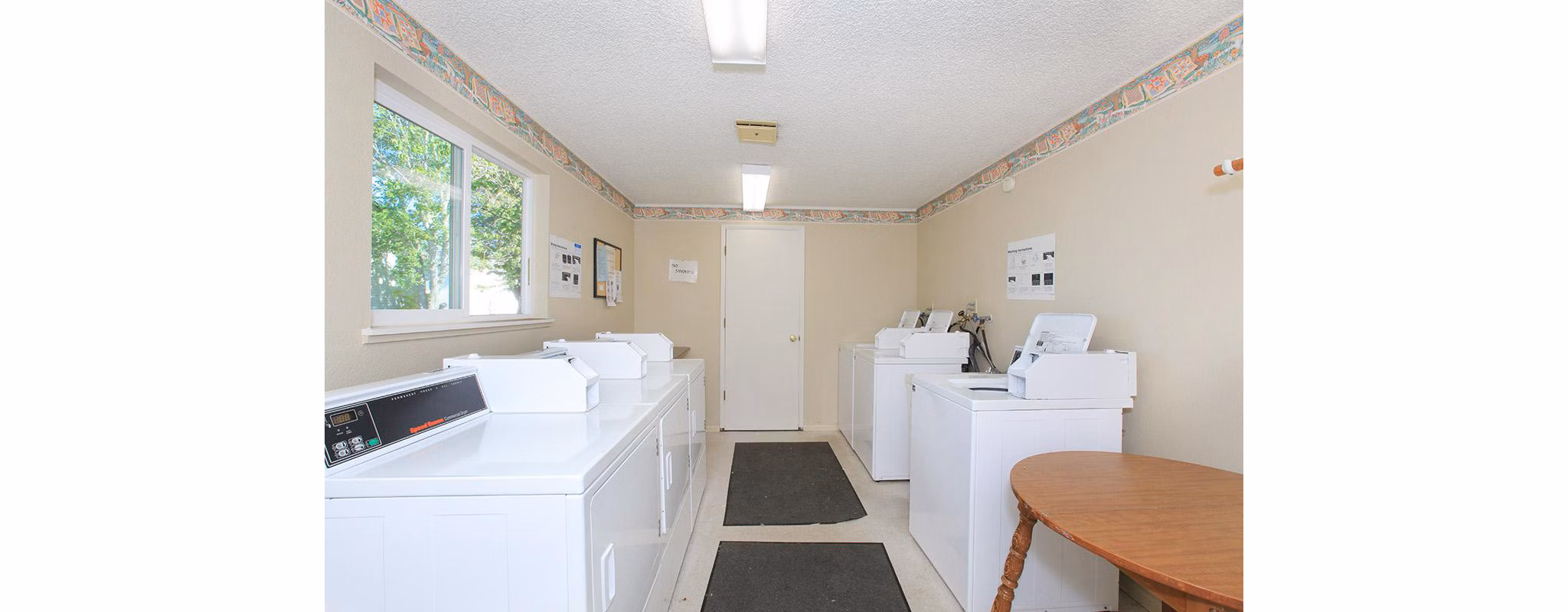 Modern laundry facility with high-efficiency machines at Redwood Park Apartments, ensuring convenience and efficiency for residents