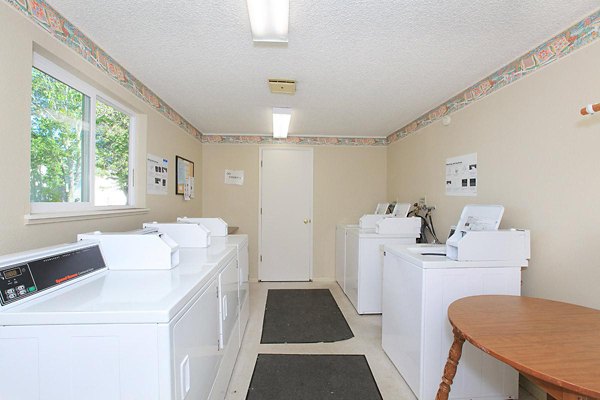 Modern laundry facility with high-efficiency machines at Redwood Park Apartments, ensuring convenience and efficiency for residents