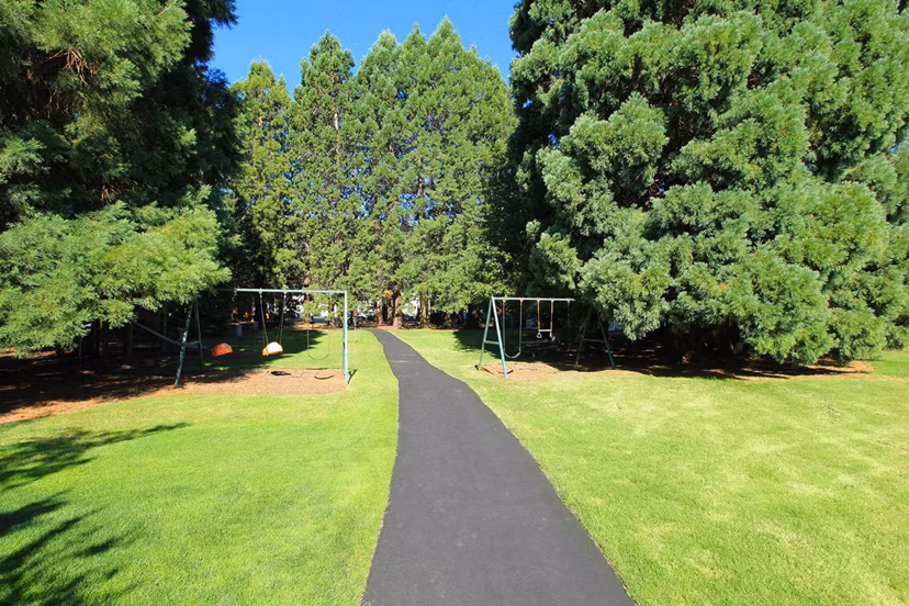 Outdoor recreational area with sports courts at Redwood Park Apartments