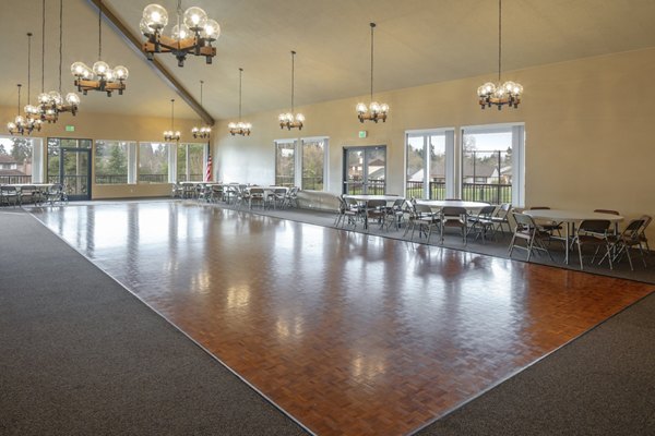 Modern meeting facility with large conference table and seating at Summerfield Apartments, perfect for business gatherings and collaborative work sessions