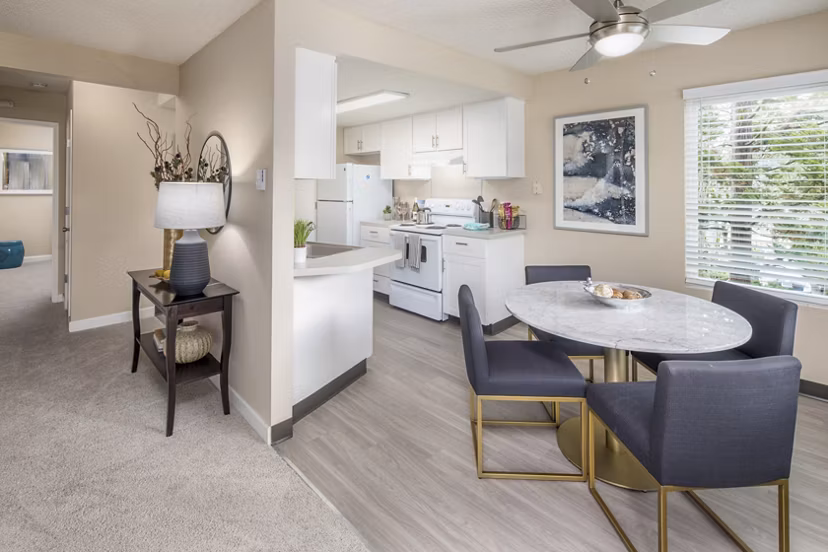 Dining area with contemporary furnishings in Summerfield Apartments at Greystar, showcasing stylish interior design and comfortable seating