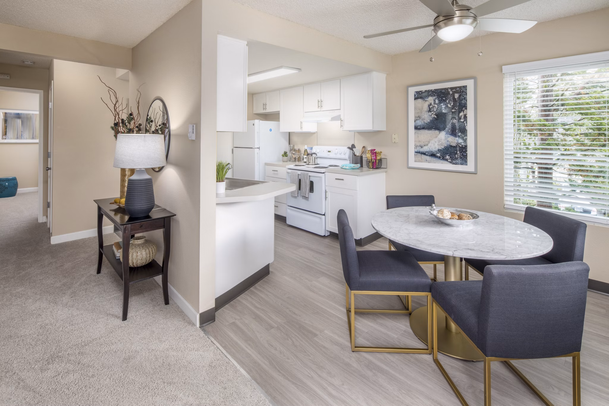 Dining area with contemporary furnishings in Summerfield Apartments at Greystar, showcasing stylish interior design and comfortable seating