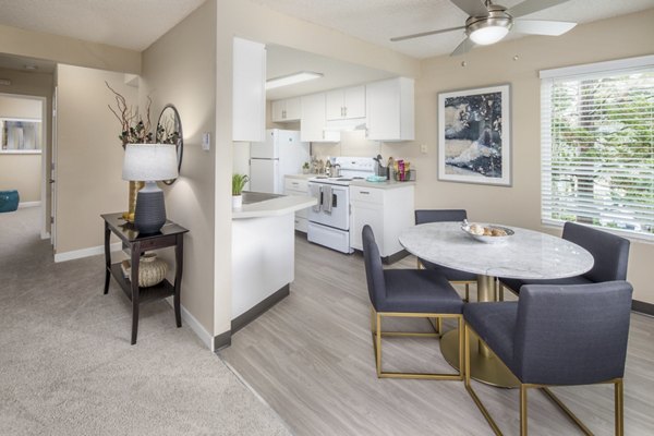 Dining area with contemporary furnishings in Summerfield Apartments at Greystar, showcasing stylish interior design and comfortable seating
