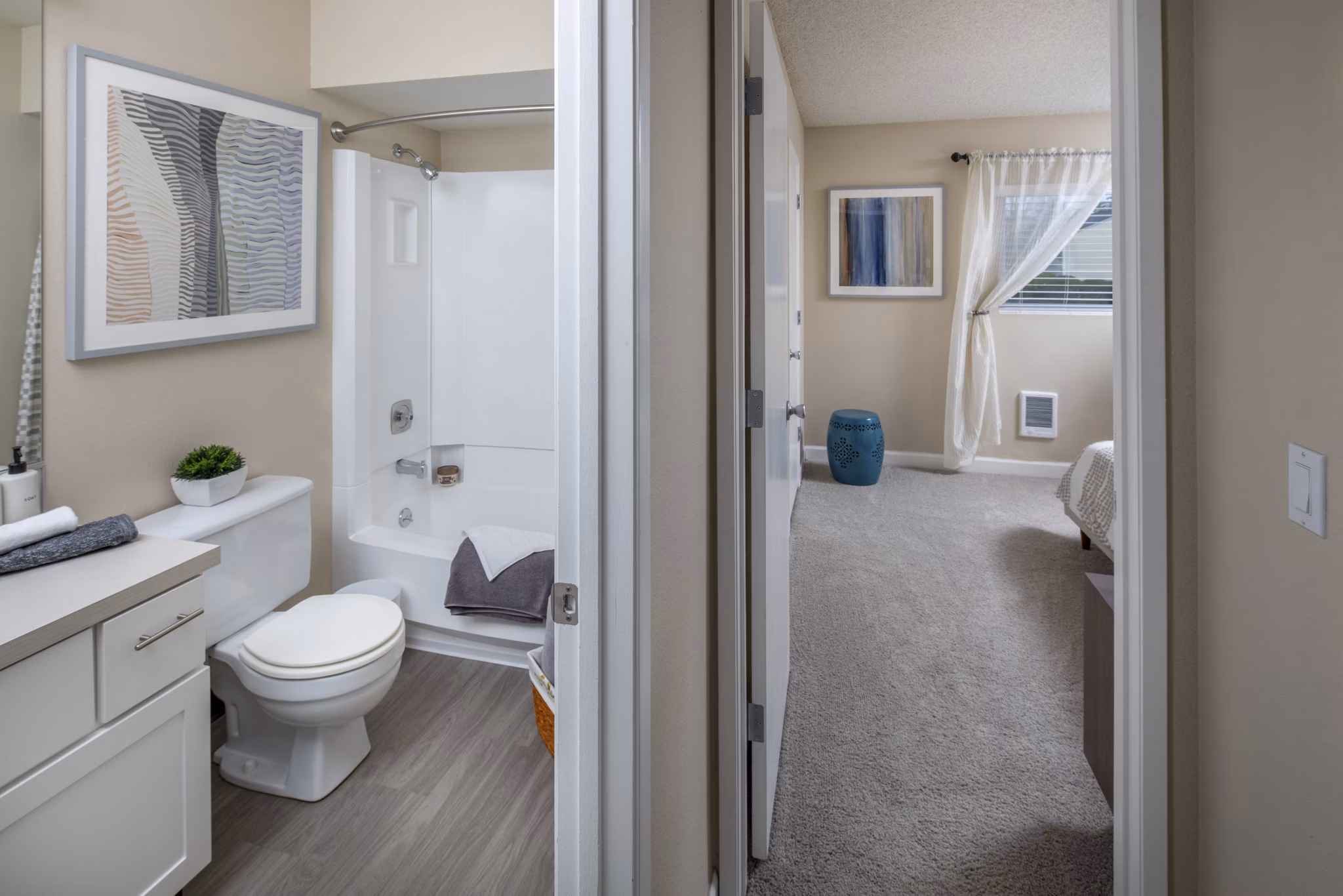 Hallway with modern lighting and art at Summerfield Apartments