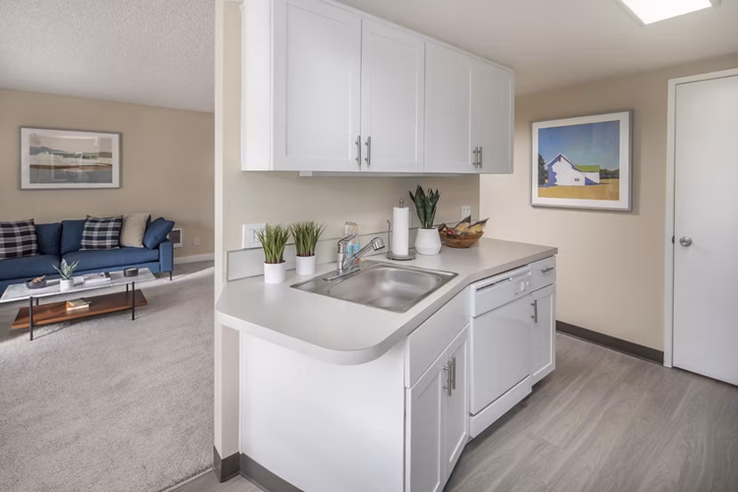 Modern kitchen with stainless steel appliances and granite countertops at Summerfield Apartments